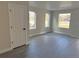 Bright, open living area with large windows and gray laminate flooring at 1642 N Lafayette St # 2, Denver, CO 80218