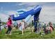 Children playing around a large blue balloon art piece and blowing bubbles on a green lawn at 1642 N Lafayette St # 2, Denver, CO 80218