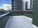 Spacious rooftop deck with modern tiling and city views in the background at 1642 N Lafayette St # 2, Denver, CO 80218