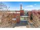 A brick building with a chimney and flags, identified as Whittier School, under a bright blue sky at 1642 N Lafayette St # 2, Denver, CO 80218
