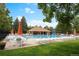 Community pool with lounge chairs and umbrellas at 9726 Jellison St, Broomfield, CO 80021