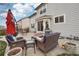 Inviting patio with wicker furniture set, outdoor dining, and lush landscaping for relaxation at 5826 Sunburst Ave, Firestone, CO 80504