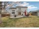 Home showcasing large windows, patio, and fire pit in a spacious landscaped backyard at 5826 Sunburst Ave, Firestone, CO 80504