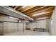 Open basement with exposed ceiling, and concrete walls ready for customization at 5826 Sunburst Ave, Firestone, CO 80504