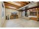 Spacious basement area showcasing exposed ceiling, modern fireplace, and ample space at 5826 Sunburst Ave, Firestone, CO 80504