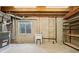 Unfinished basement with utility sink, shelving, and a small window for natural light at 5826 Sunburst Ave, Firestone, CO 80504