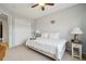 Comfortable bedroom features a ceiling fan, neutral carpet and plenty of natural light at 5826 Sunburst Ave, Firestone, CO 80504