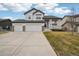 Inviting two-story home with a covered porch, well-maintained lawn, and a convenient two-car garage at 5826 Sunburst Ave, Firestone, CO 80504