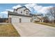 Traditional two-story home with a two-car garage, covered porch, and a well-manicured front yard at 5826 Sunburst Ave, Firestone, CO 80504