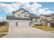 Charming two-story home with a covered front porch, stone accents, and a spacious two-car garage at 5826 Sunburst Ave, Firestone, CO 80504