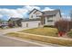 Beautiful two-story home with a covered porch, manicured lawn, and a convenient two-car garage and mature trees at 5826 Sunburst Ave, Firestone, CO 80504