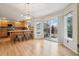 Bright eat-in kitchen features hardwood floors, a breakfast bar with seating, and sliding doors to the backyard at 5826 Sunburst Ave, Firestone, CO 80504