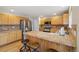Updated kitchen features stainless appliances, and breakfast bar seating at 5826 Sunburst Ave, Firestone, CO 80504