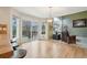 Well-lit living area adjacent to kitchen and patio entrance, showcasing open layout at 5826 Sunburst Ave, Firestone, CO 80504