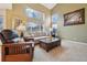 Bright living room featuring large windows, neutral decor, and comfortable seating at 5826 Sunburst Ave, Firestone, CO 80504