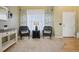 Inviting living room featuring stylish decor, large windows, and a seamless transition to hardwood floors at 5826 Sunburst Ave, Firestone, CO 80504
