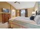 Inviting main bedroom featuring a vaulted ceiling, decorative dresser, and ensuite bathroom access at 5826 Sunburst Ave, Firestone, CO 80504