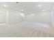 Unfinished basement featuring carpeted floors, white walls, and access to the upper levels at 6187 E 155Th Pl, Thornton, CO 80602