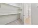 A well-organized walk-in closet featuring shelving and carpeted floor at 6187 E 155Th Pl, Thornton, CO 80602