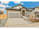 Charming home featuring stone accents, a two-car garage, and a well-maintained driveway at 6187 E 155Th Pl, Thornton, CO 80602