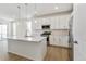 Modern kitchen with stainless steel appliances, white cabinetry, and stylish pendant lighting at 6187 E 155Th Pl, Thornton, CO 80602