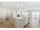 Open concept kitchen with a large island, stainless steel appliances, and adjacent Gathering room at 6187 E 155Th Pl, Thornton, CO 80602