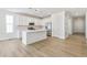 Modern kitchen with white cabinets, an island with seating, and stainless steel appliances at 6187 E 155Th Pl, Thornton, CO 80602
