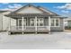 Back exterior of a gray single-story home, showcasing the covered back porch and backyard at 6187 E 155Th Pl, Thornton, CO 80602