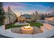 A luxurious backyard features a fire pit, pool, seating, and immaculate landscaping at 140 Race St, Denver, CO 80206