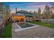 An elegant backyard features a pool, patio, manicured lawn, and architectural details at 140 Race St, Denver, CO 80206