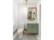 Chic bathroom showcasing patterned tiles, a green vanity, and modern fixtures at 140 Race St, Denver, CO 80206