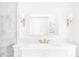 Elegant bathroom featuring a white vanity, ornate mirror and sconces, and decorative tiling at 140 Race St, Denver, CO 80206
