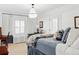 Bright bedroom with a chandelier, white walls, carpet, and a window that lets in natural light at 140 Race St, Denver, CO 80206