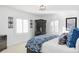 Bright bedroom with large windows, wardrobe, and a blue patterned bedspread and throw pillows at 140 Race St, Denver, CO 80206