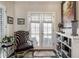 Elegant entryway with french doors, stylish chair, and custom shelving at 140 Race St, Denver, CO 80206