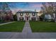 Stately two-story home with a green tile roof and a manicured front lawn at 140 Race St, Denver, CO 80206