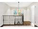 Upstairs hallway boasting hardwood floors, decorative railing and trim, and bright natural light at 140 Race St, Denver, CO 80206