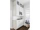 Kitchen featuring white cabinets, marble countertops, tiled backsplash, built in coffee machine, and breakfast nook at 140 Race St, Denver, CO 80206