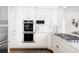 Bright kitchen with white cabinets, marble countertops, tiled backsplash, and stainless steel appliances at 140 Race St, Denver, CO 80206