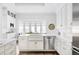Spacious kitchen with white cabinets, marble countertops, stainless steel appliances, and a bay window at 140 Race St, Denver, CO 80206