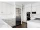 Bright kitchen with stainless steel appliances, white cabinets, marble countertops, and tiled backsplash at 140 Race St, Denver, CO 80206