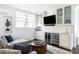 Cozy living room with a sofa, side table, bar area, and bright window at 140 Race St, Denver, CO 80206