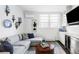 Inviting living room featuring a comfortable sofa, custom shelving, and a stylish wet bar area at 140 Race St, Denver, CO 80206