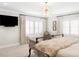 Spacious main bedroom featuring plantation shutters, stylish chandelier, and comfortable seating at 140 Race St, Denver, CO 80206