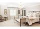 Serene bedroom with large windows, neutral tones, and a metal frame bed and bench at 140 Race St, Denver, CO 80206