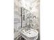 Chic powder room featuring patterned wallpaper, marble sink, and decorative lighting at 140 Race St, Denver, CO 80206