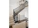 Elegant staircase featuring a wrought iron railing, carpeted steps, and a stylish chandelier at 140 Race St, Denver, CO 80206