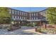 Red brick commercial building 'Parker Station' with multiple shops and outdoor seating at 11029 Snowdon St, Parker, CO 80134