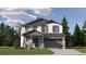 Charming two-story home with a manicured lawn, gray trim, and stone accents on the facade at 11029 Snowdon St, Parker, CO 80134