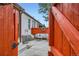 Backyard patio with red privacy fence and comfortable outdoor seating at 1217 E 26Th Ave, Denver, CO 80205